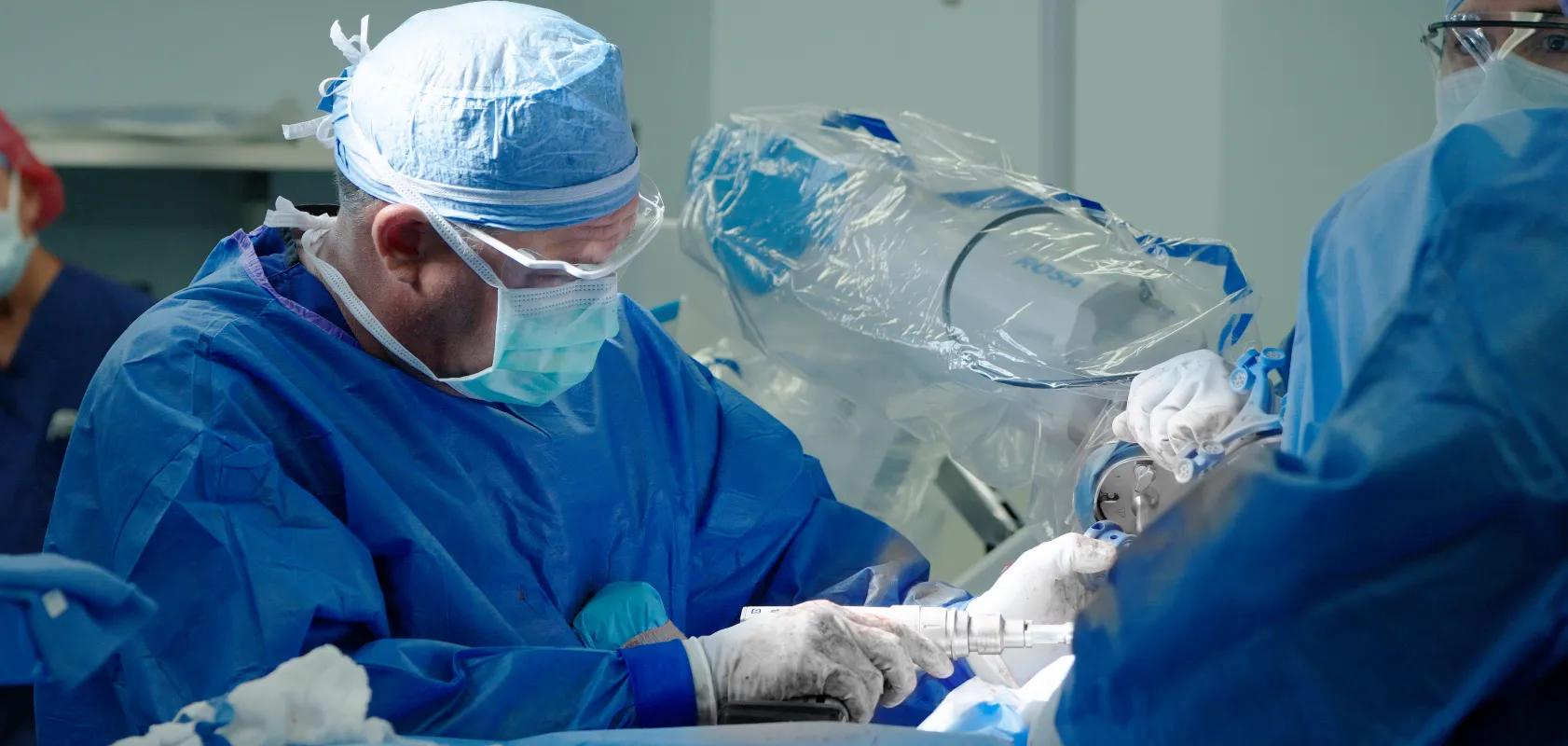 An OSS Health surgeon performs a knee replacement in an operating room.